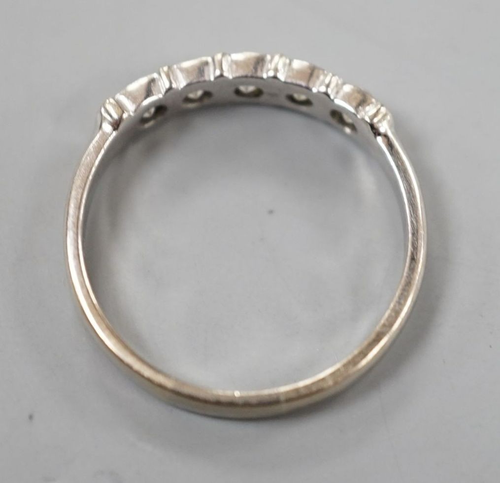 An 18ct white metal and five stone diamond set half hoop ring, size R, gross weight 3.4 grams.